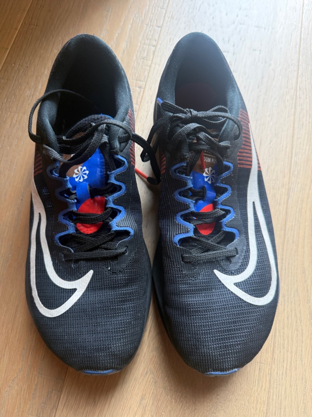 Nike Black Sneakers with White Swoosh and Blue & Red Accents